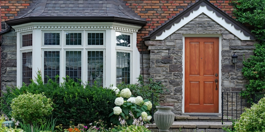 tinted bay windows photo of the exterior of a home with bay windows