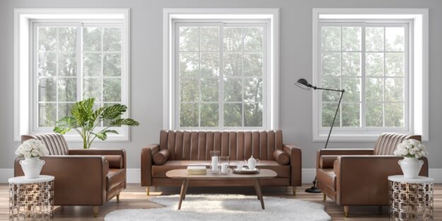 living room with neutral-toned furniture and 3 large windows