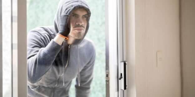 burglar looking in a house burglar looking in a house