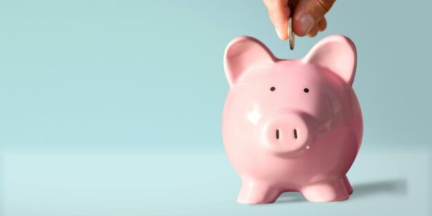 a coin deposited into a piggy bank