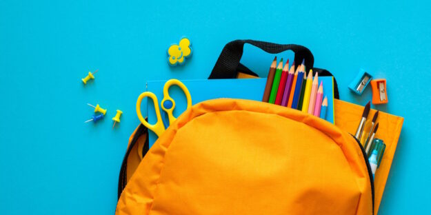 Back to school concept. Backpack with school supplies. Top view. student backpack with school supplies with blue background