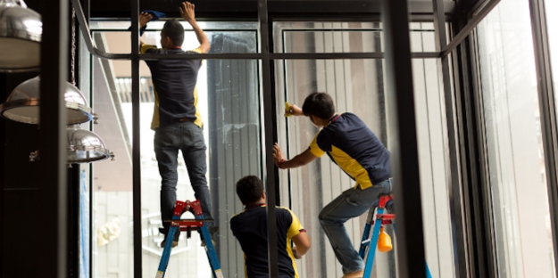 men applying residential window tinting men applying residential window tinting