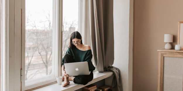 woman working by window woman working by window