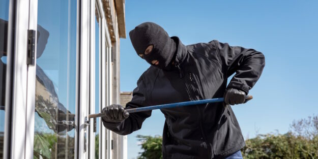 burglar breaking in window burglar breaking in window