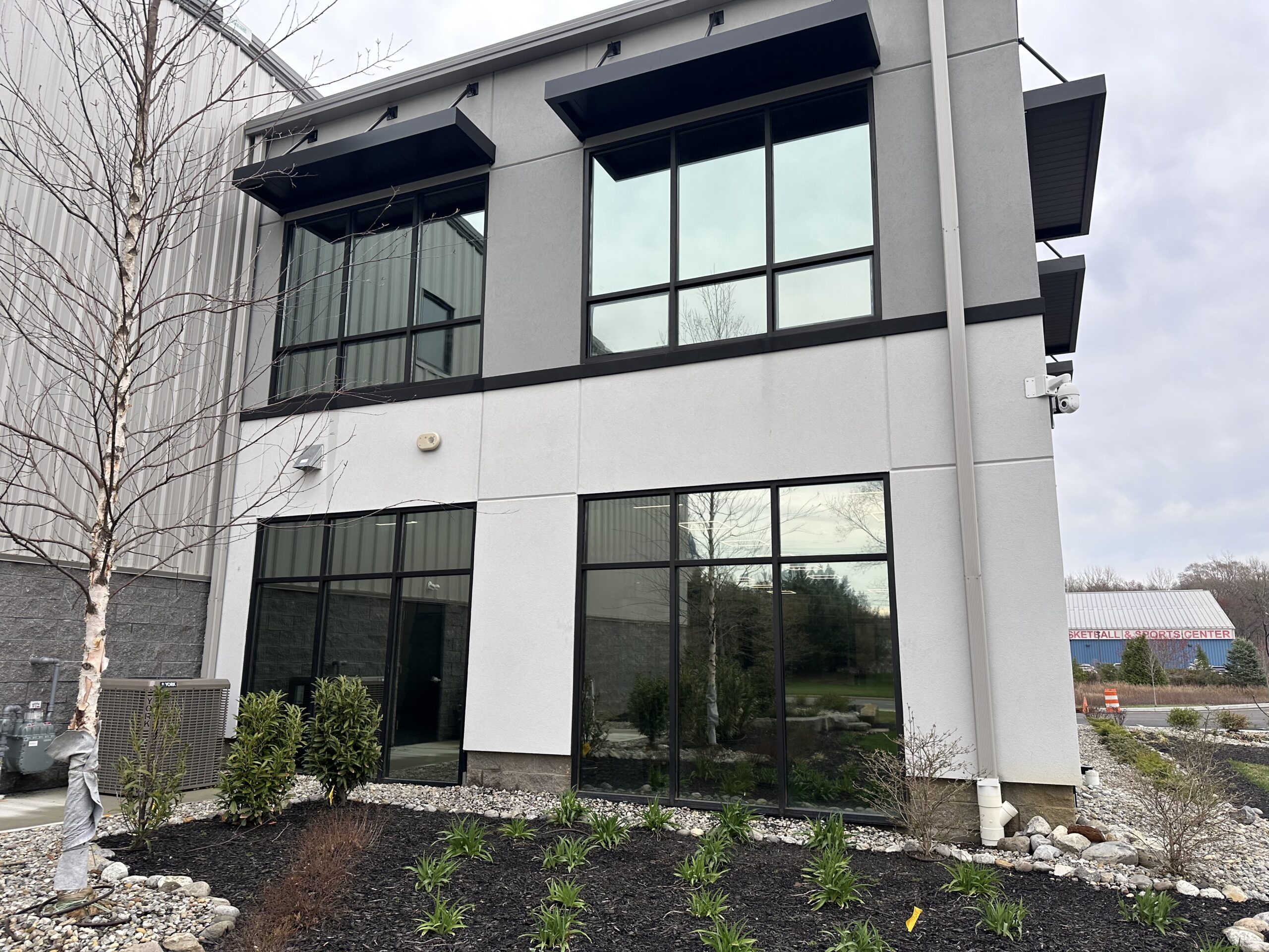 Exterior of a commercial building with professionally installed window tint by Energy Solutions Window Tinting, reducing glare and enhancing energy efficiency.